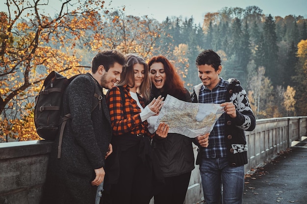 group young people are looking map where they are while walking autumn forest 613910 15159